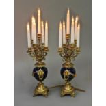 A PAIR OF GILT METAL AND BLUE ENAMEL SIX BRANCH CANDELABRA, each with deep blue enamelled vase