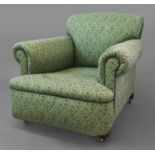 A VICTORIAN 'HOWARD' STYLE ARMCHAIR, all-over upholstered in a green foliate fabric, with a deep