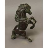 A CAST AND PATINATED BRONZE STUDY OF A REARING HORSE, the horse with flowing mane and tail rearing