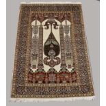 KASHMIR SILK PILED PRAYER RUG, modern. The ivory field with triple Mihrab above urns issuing