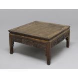 A CHINESE HARDWOOD 'MAHJONG' TABLE, the square panelled top above a relief carved frieze with a