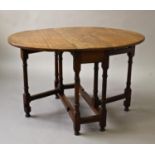 A LIGHT OAK GATELEG TABLE, the oval top with drop flap sides on turned legs with square section