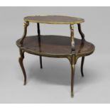 FRENCH TWO TIER ETAGERE each tier of shaped oval form, with gilt brass rams head mounts and brass