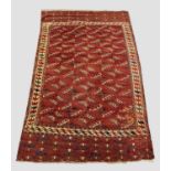 YOMUT TURKMEN MAIN CARPET, east Caspian region, 1850 or earlier. The chestnut brown field of