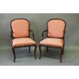 A PAIR OF LOUIS XVI STYLE ARMCHAIRS, each with upholstered backs and seats within leaf carved frames