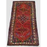 SEYCHOUR RUG, East Caucasus, circa 1910. The brick red elongated lozenge field of tribal and