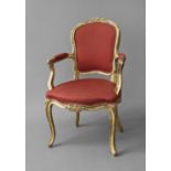 AN 18TH/19TH CENTURY FRENCH GILTWOOD SALON CHAIR, the shaped upholstered back within a moulded frame