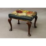 A QUEEN ANNE WALNUT CABRIOLE LEG STOOL, the rectangular seat with tapestry effect upholstery and