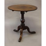 A GEORGE III MAHOGANY TRIPOD TABLE, the circular top on a baluster turned column and three down