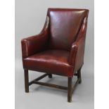 A VICTORIAN STYLE RED LEATHER UPHOLSTERED ARM CHAIR, with a low back and raised arms upholstered