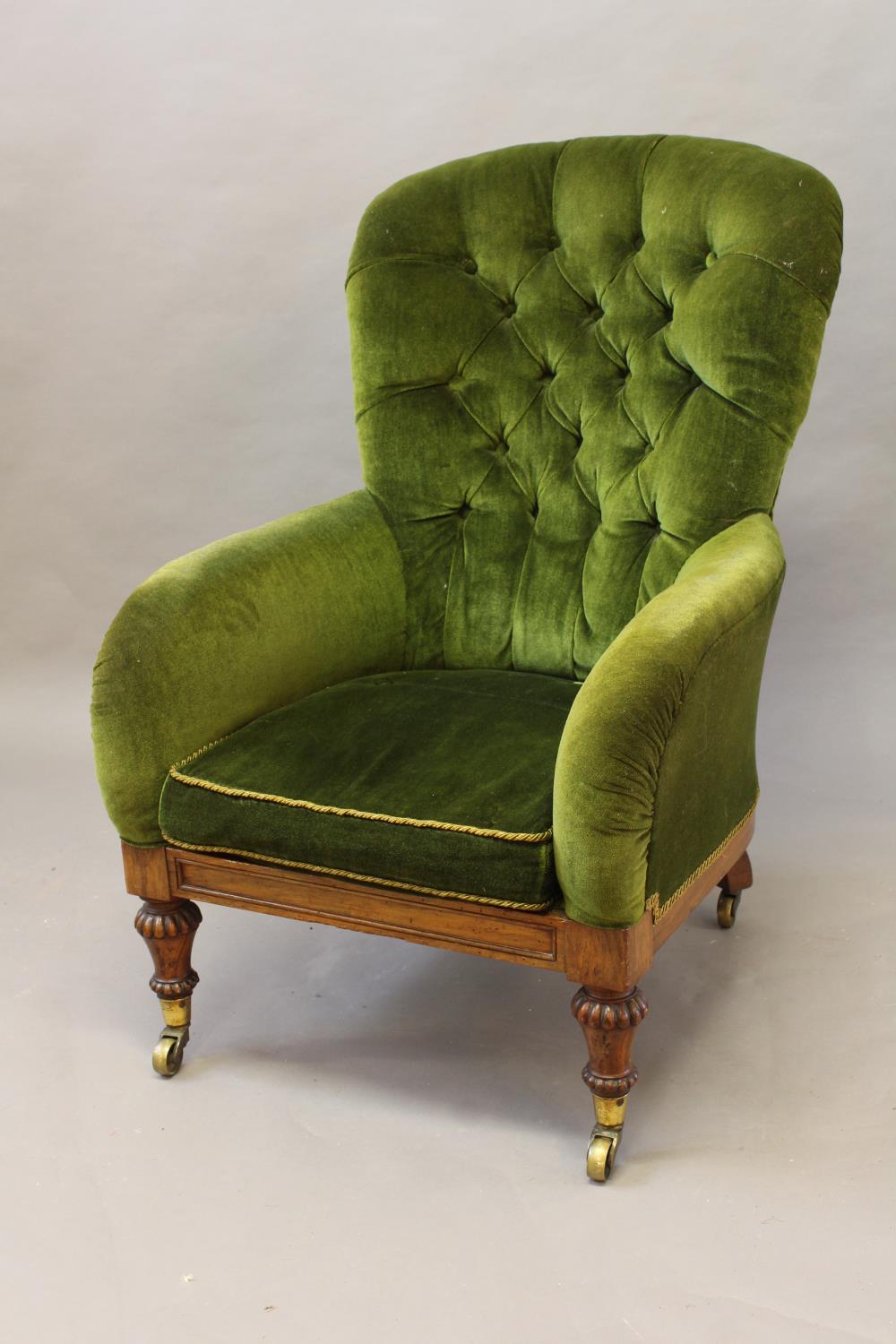 A REGENCY ROSEWOOD UPHOLSTERED LIBRARY CHAIR, with button upholstered back and low arms above a