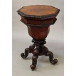 A VICTORIAN MAHOGANY TEA POY, with an octagonal top with radiating figured veneers and carved leaf