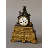 A FRENCH BRONZE AND ORMOLU MANTLE CLOCK BY H. MARC OF PARIS, the white enamelled dial signed H.