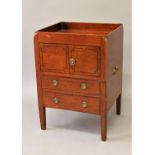 A REGENCY MAHOGANY BEDSIDE COMMODE, the rectangular top with raised border above twin cupboard doors