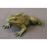 A GARDEN SCULPTURE OF A BRONZE FROG, with head raised, 55cm x 49cm.