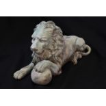 A SCULPTURAL BRONZE EFFECT HERALDIC LION, the lion recumbent with left paw resting on a ball, 25cm