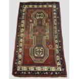 KAZAK RUG, Central Caucasus, circa 1880. The madder field with double 'key hole' panel containing