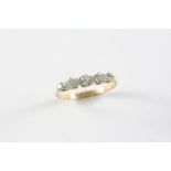 A DIAMOND FIVE STONE RING set with five graduated circular-cut diamonds, in 18ct gold. Size T 1/2