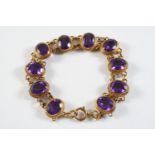 AN AMETHYST AND GOLD BRACELET the ten oval-shaped amethysts are collet set in gold mounts with