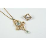 AN EDWARDIAN AQUAMARINE AND PEARL SET PENDANT the 15ct gold openwork scrolling mount centred with an