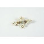 AN ENAMEL, DIAMOND AND PEARL BROOCH the central enamel flowerhead is set with a small pearl, with