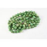 A SINGLE ROW UNIFORM JADE BEAD NECKLACE the jade beads measure approximately 9.7mm, 112cm long