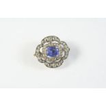 A VICTORIAN QUATREFOIL SAPPHIRE AND DIAMOND BROOCH the oval-shaped sapphire is set within a surround