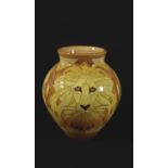 DENNIS CHINA WORKS VASE - LION a tube lined vase in the Lion design, with three Lion's faces on an