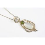 A MOONSTONE AND PERIDOT PENDANT the silver openwork mount is set with a large oval-shaped