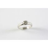 A DIAMOND SOLITAIRE RING the round brilliant-cut diamond weighs 0.74 carats and is set in