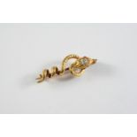 A GOLD AND DIAMOND SNAKE BROOCH the gold coiling snake has a pear-shaped diamond mounted to its