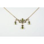 A PERIDOT AND DIAMOND NECKLACE the scrolling and foliate design is centred with a rectangular-shaped