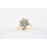 A DIAMOND CLUSTER RING the flowerhead design is set with seven circular-cut diamonds in 18ct