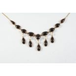 A GARNET AND GOLD DROP NECKLACE the gold chain necklace mounted with oval and pear-shaped collet set