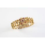 A GOLD, RUBY, DIAMOND AND PEARL SET EXPANDING BRACELET the oval link flexible bracelet is centred