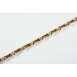 A DIAMOND AND GOLD BRACELET formed alternately with circular-cut diamonds in gold collet settings