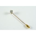 A DIAMOND STICK PIN mounted with a brilliant-cut diamond, in gold