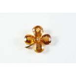 A CITRINE FOLIATE BROOCH formed with four pear-shaped citrines in yellow gold, 3.5cm wide