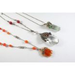 AN ARTS AND CRAFTS SILVER, CRYSTAL,MOONSTONE AND CARNELIAN PENDANT the pear-shaped crystal drop with