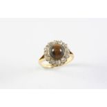 A TIGER'S EYE AND DIAMOND CLUSTER RING the circular cabochon tiger's eye is set within a surround of