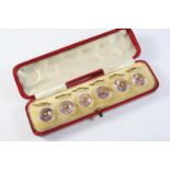 A CASED SET OF SIX AMETHYST AND GOLD DRESS BUTTONS