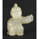 CHINESE JADE PENDANT a yellow jade miniature pendant in the form of a crouching boy with arm
