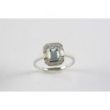AN AQUAMARINE AND DIAMOND CLUSTER RING the step-cut aquamarine is set within a surround of two