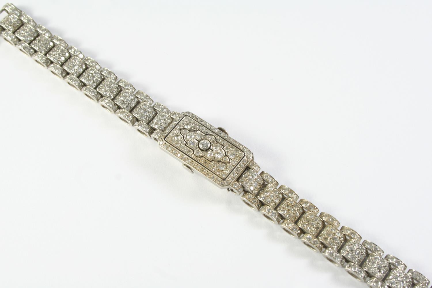 AN ART DECO LADY'S DIAMOND COCKTAIL WRISTWATCH millegrain set overall with circular-cut diamonds,