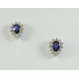 A PAIR OF SAPPHIRE AND DIAMOND CLUSTER STUD EARRINGS each earring set with a pear-shaped sapphire