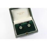 A PAIR OF EMERALD AND DIAMOND CLUSTER STUD EARRINGS of flowerhead form, each earring set with a