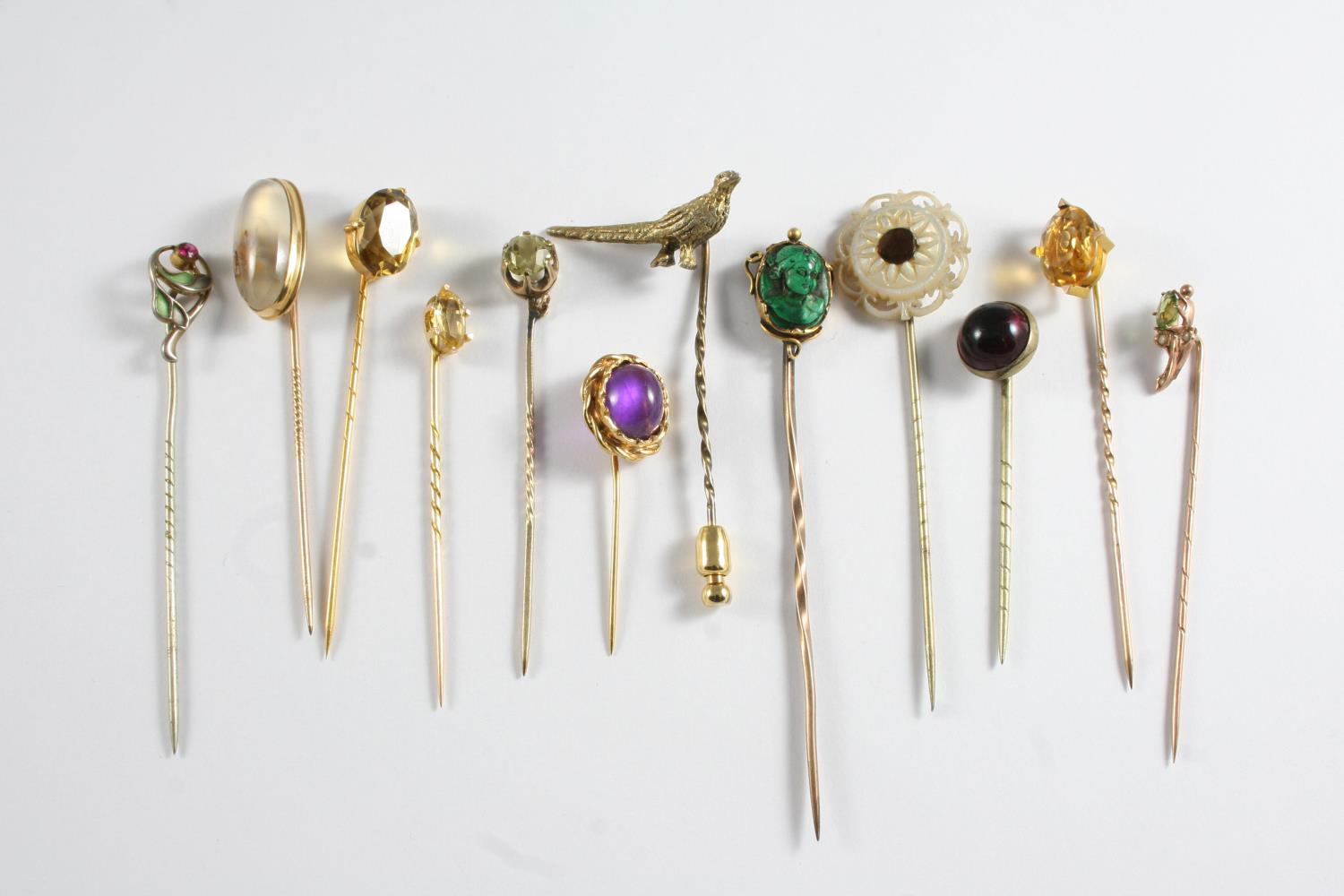 TWENTY SIX ASSORTED STICK PINS a garnet and seed pearl cluster stick pin, a gold stick pin mounted