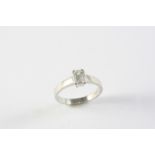A DIAMOND SOLITAIRE RING set with an emerald-cut diamond in platinum. Size M 1/2