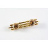 A GOLD, TIGER'S-EYE AND DIAMOND BROOCH the gold three bar brooch is mounted with two tiger's-eye and