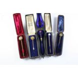 TWELVE ASSORTED CASED STICK PINS including a gold stick pin mounted with carved agate inscribed with